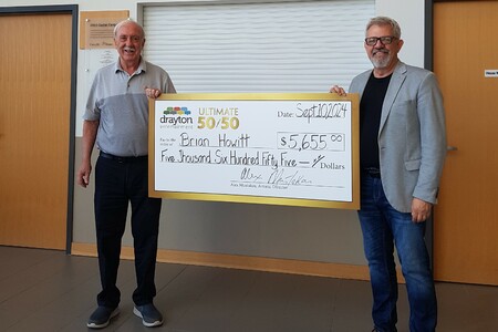 Artistic Director Alex Mustakas Presents Cheque to August 50/50 Winner Brian Howitt<