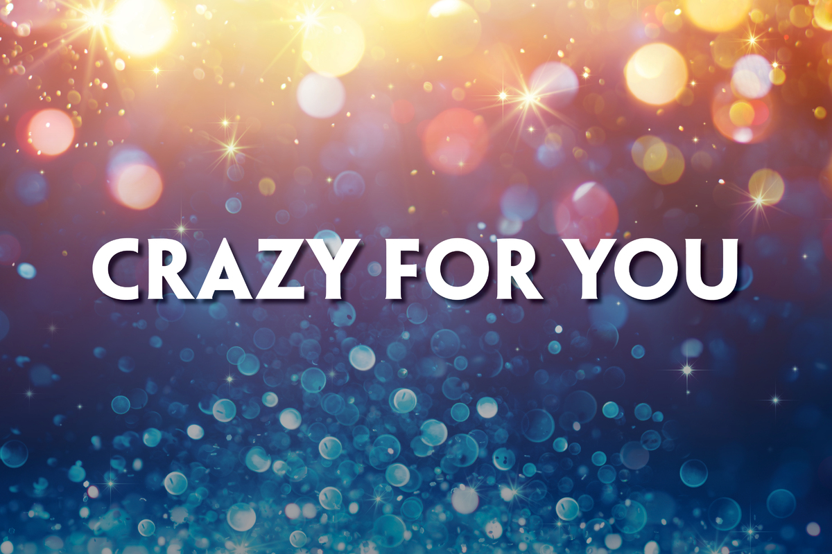 This promotional image for Crazy for You features the title in bold, white letters against a sparkling, bokeh background. The backdrop transitions from warm golden tones at the top to cool blues at the bottom, evoking a lively and festive atmosphere.