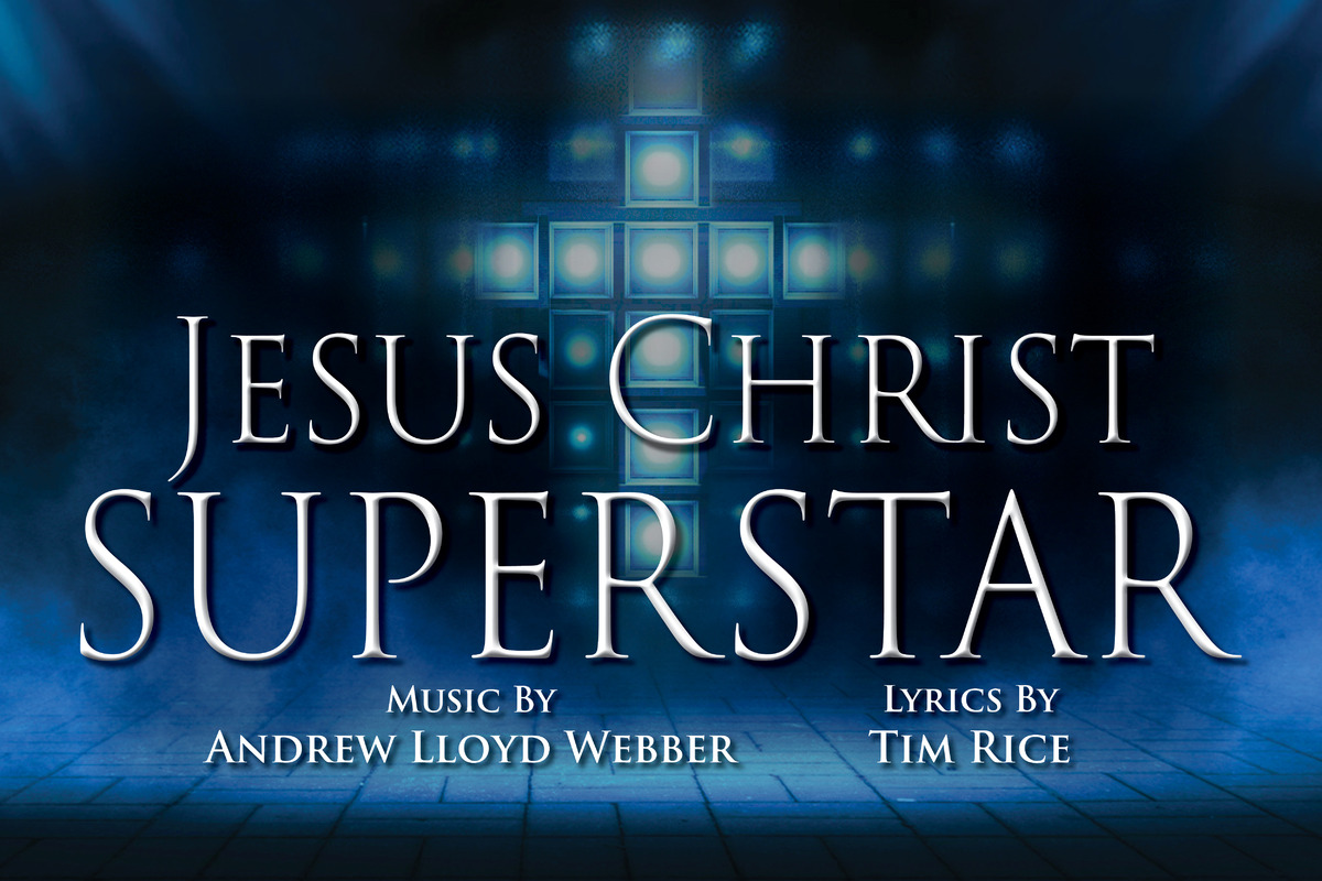 This promotional image for Jesus Christ Superstar features the title in bold, white letters against a sparkling, bokeh background. The backdrop transitions from warm golden hues at the top to cool blues at the bottom, with light sparkles adding a sen