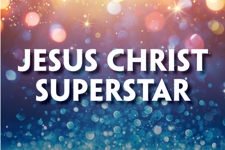 This promotional image for Jesus Christ Superstar features the title in bold, white letters against a sparkling, bokeh background. The backdrop transitions from warm golden hues at the top to cool blues at the bottom, with light sparkles adding a sen